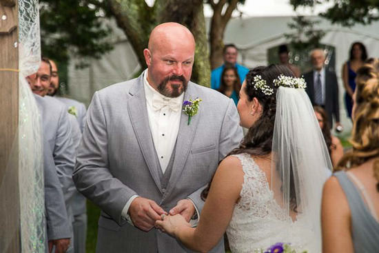 Bride and groom holding hands at their outdoor wedding.