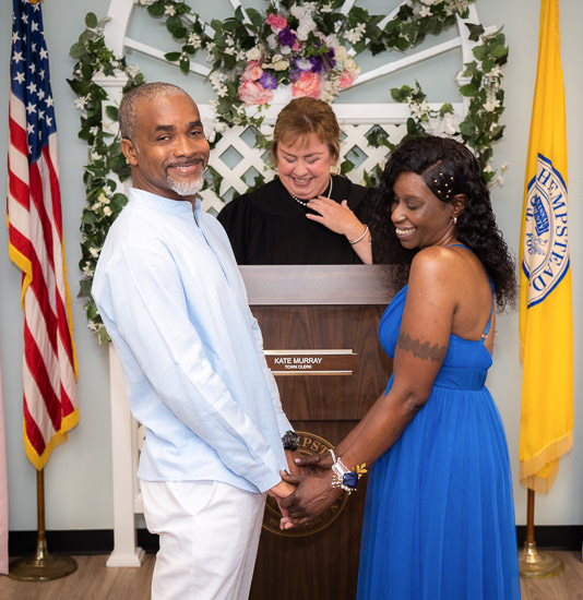 Couple getting married by a town clerk.