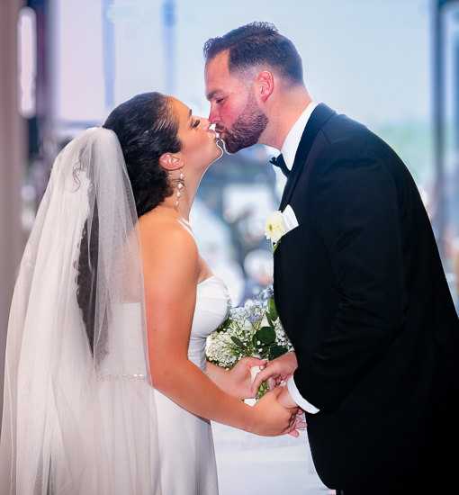 Newlyweds share a kiss on their wedding day.