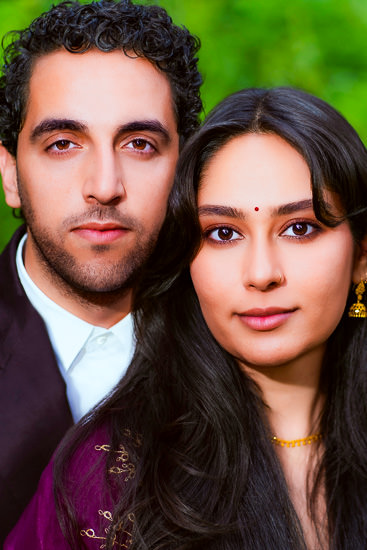 Outdoors closeup portrait of young man and woman they are looking at the camera
